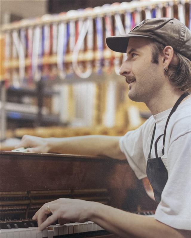 Evan Micheels at an upright piano